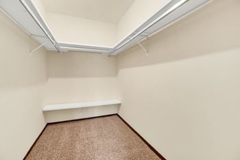 A room with a brown carpet and a white ceiling.